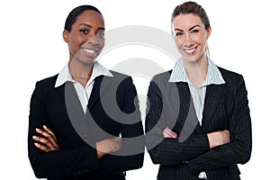 Happy businesswomen with arms crossed