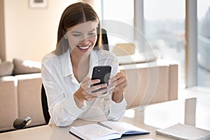 Happy busy young business woman using mobile phone