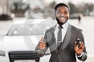 Happy Buyer Holding Keys Near New Car