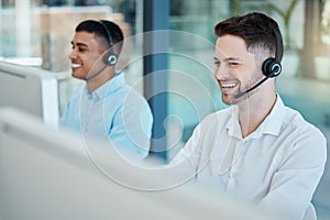 Happy call center, consultant man laugh on customer service phone call and happiness in office. Customer support team