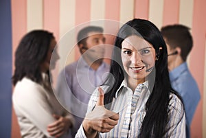 Happy call center woman giving thumbs up