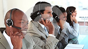 Happy call centre agents talking with their headsets