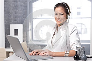 Happy call dispatcher with laptop