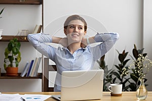 Happy calm business woman employee take break at work desk