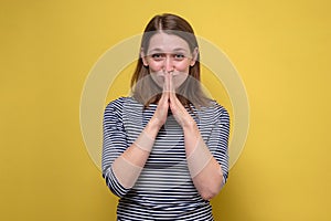 Happy calm grateful teen girl join hands praying thanking hoping believing, smiling.