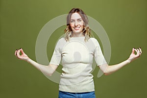 Happy calm healthy young woman show mudra gesture practicing yoga exercise, meditating, breathing. Stress relief concept