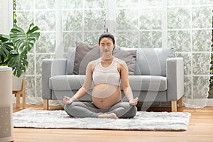 Happy Calm Pregnant Woman deep breath with fresh air do yoga lotus pose comfortable at home,Pregnancy of young woman relax with