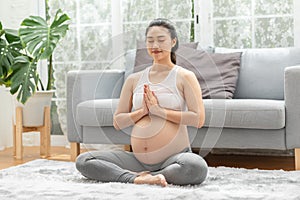 Happy Calm Pregnant Woman deep breath with fresh air do yoga lotus pose comfortable at home,Pregnancy of young woman relax with