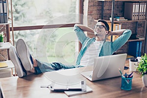 Happy calm smiling man having a rest after solving all the tasks