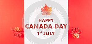Happy Canada Day concept made from red silk maple leaves with the text on white and red background