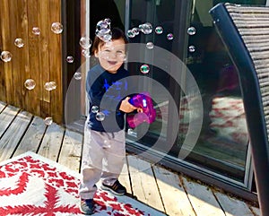 Happy Canadian Indigenous boy making bubbles