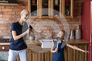 Happy cancer mom and little daughter girl having fun together