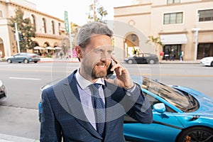 happy car rent dealer speaking on phone outdoor