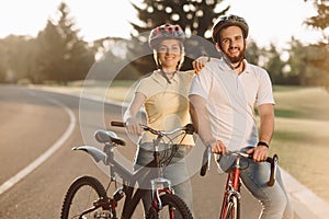 Happy carefree couple with bicycles outdoors.