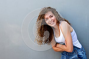 Happy carefree teen girl leaning with arms crossed