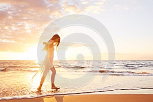 Happy Carefree Woman Dancing on the Beach at Sunset