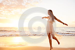 Happy Carefree Woman Dancing on the Beach at Sunset