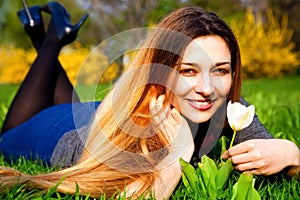 Happy carefree woman with flower and grass