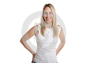 Happy carefree woman with joyful expression, smiling while standing in relaxed pose against white background