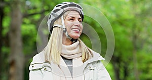 Happy, carefree woman riding a bicycle outdoors in a nature park as she lives an active and healthy lifestyle. Beautiful