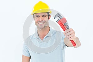 Happy carpenter holding monkey wrench