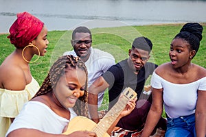 Happy casual america african people having fun and eating burger outdoors lifestyle,students for a break summer evening