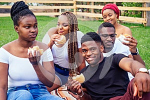 Happy casual america african people having fun and eating burger outdoors lifestyle,students for a break summer evening