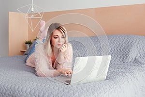 Happy casual beautiful woman working on a laptop