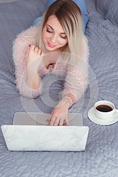 Happy casual beautiful woman working on a laptop