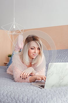 Happy casual beautiful woman working on a laptop