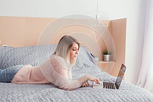 Happy casual beautiful woman working on a laptop