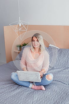 Happy casual beautiful woman working on a laptop