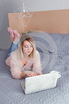 Happy casual beautiful woman working on a laptop