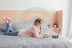 Happy casual beautiful woman working on a laptop