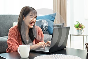 Happy casual beautiful woman working on a laptop.