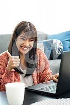 Happy casual beautiful woman working on a laptop.