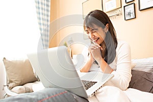 Happy casual beautiful woman working on a laptop.