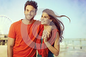 Happy casual couple walking at seascape beach