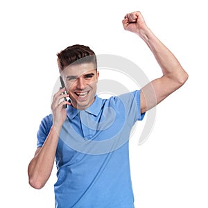 Happy casual man celebrating good news on the phone