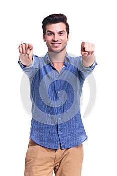 Happy casual man poining fingers