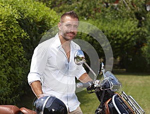 Happy casual man with scooter in garden photo