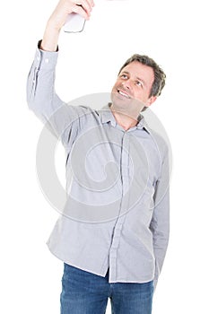 Happy casual man taking selfie over white background