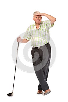 Happy casual mature golfer looking for ball