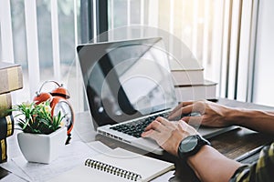 Happy casual young asian man working in home or small office wit photo