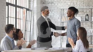 Happy Caucasian boss greeting with promotion excited employee