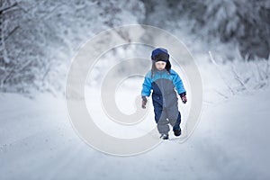 Happy caucasian child playing in snow