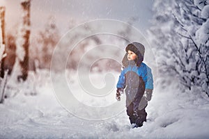 Happy caucasian child playing in snow
