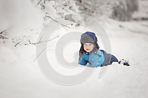 Happy caucasian child playing in snow