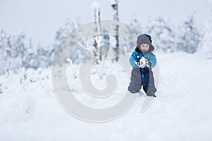 Happy caucasian child playing in snow