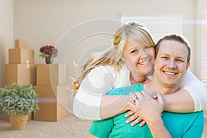 Happy Caucasian Couple Inside Empty Room with Cardboard Boxes - Moving Into New House